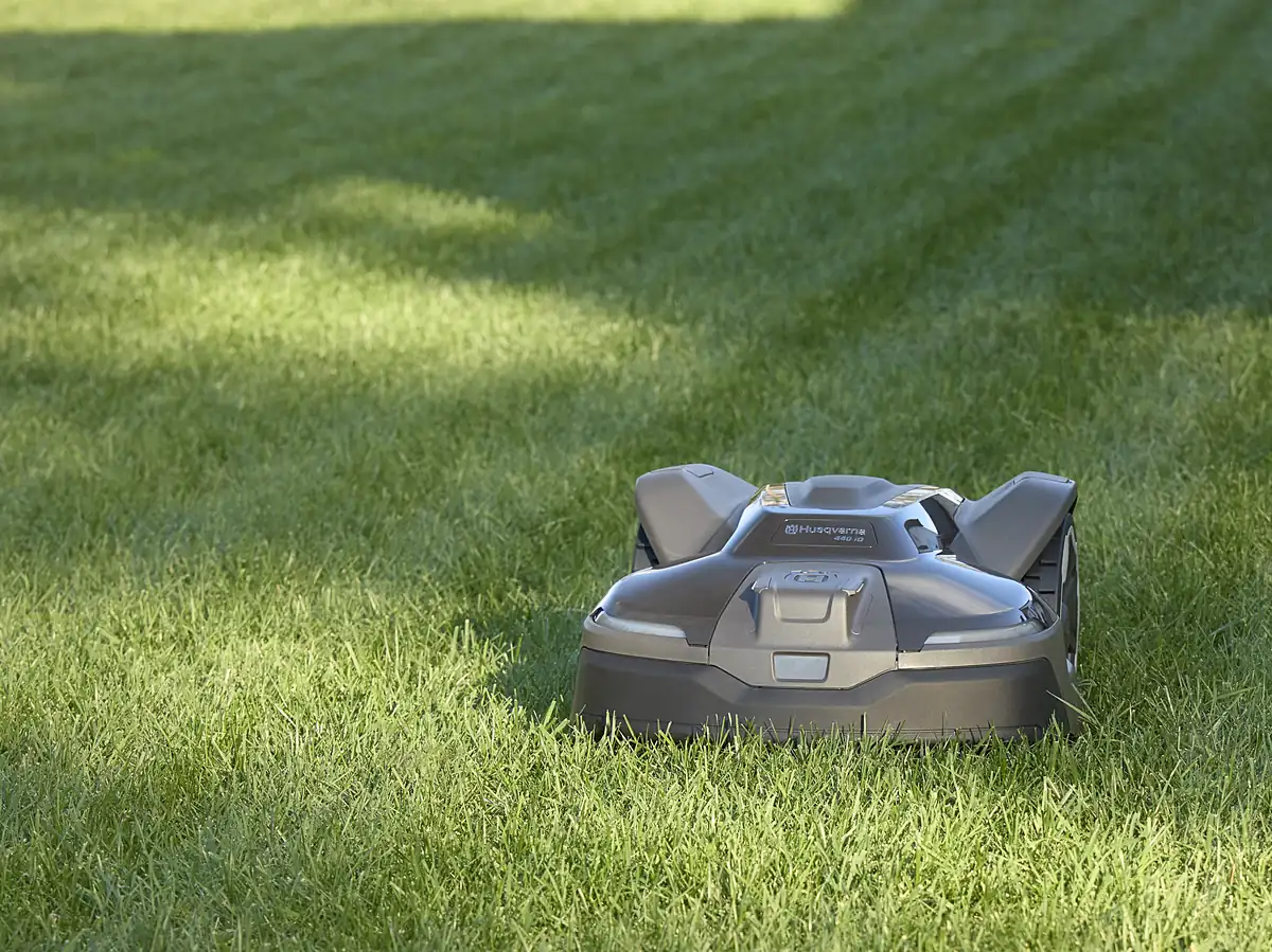 Husqvarna Automower iQ Series cutting a residential lawn