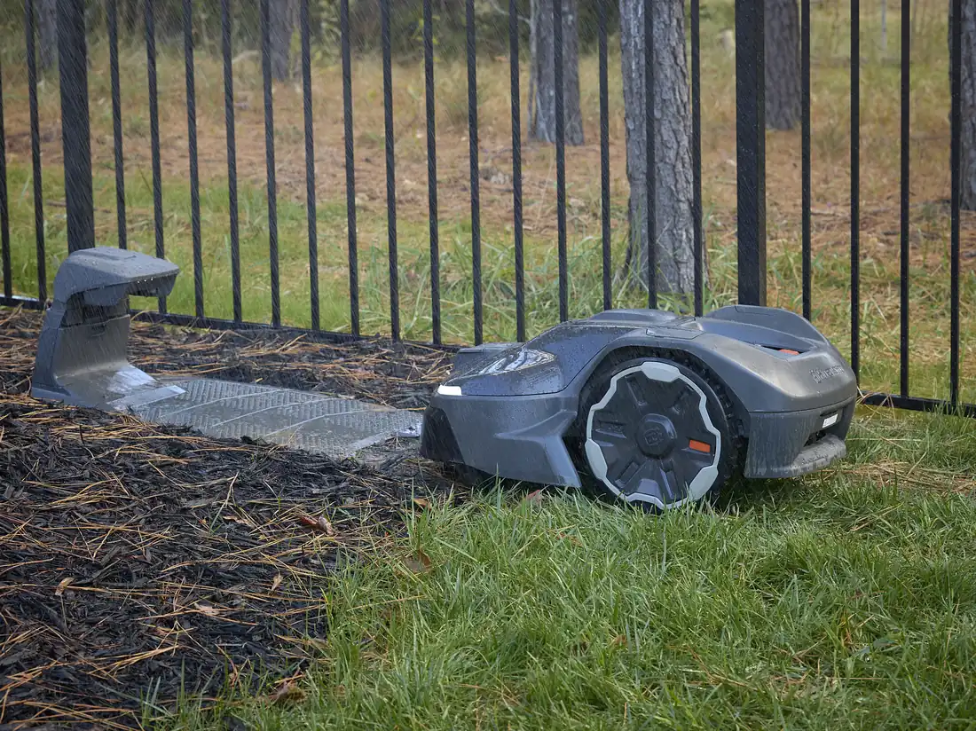 A robotic mower parked at its charging station