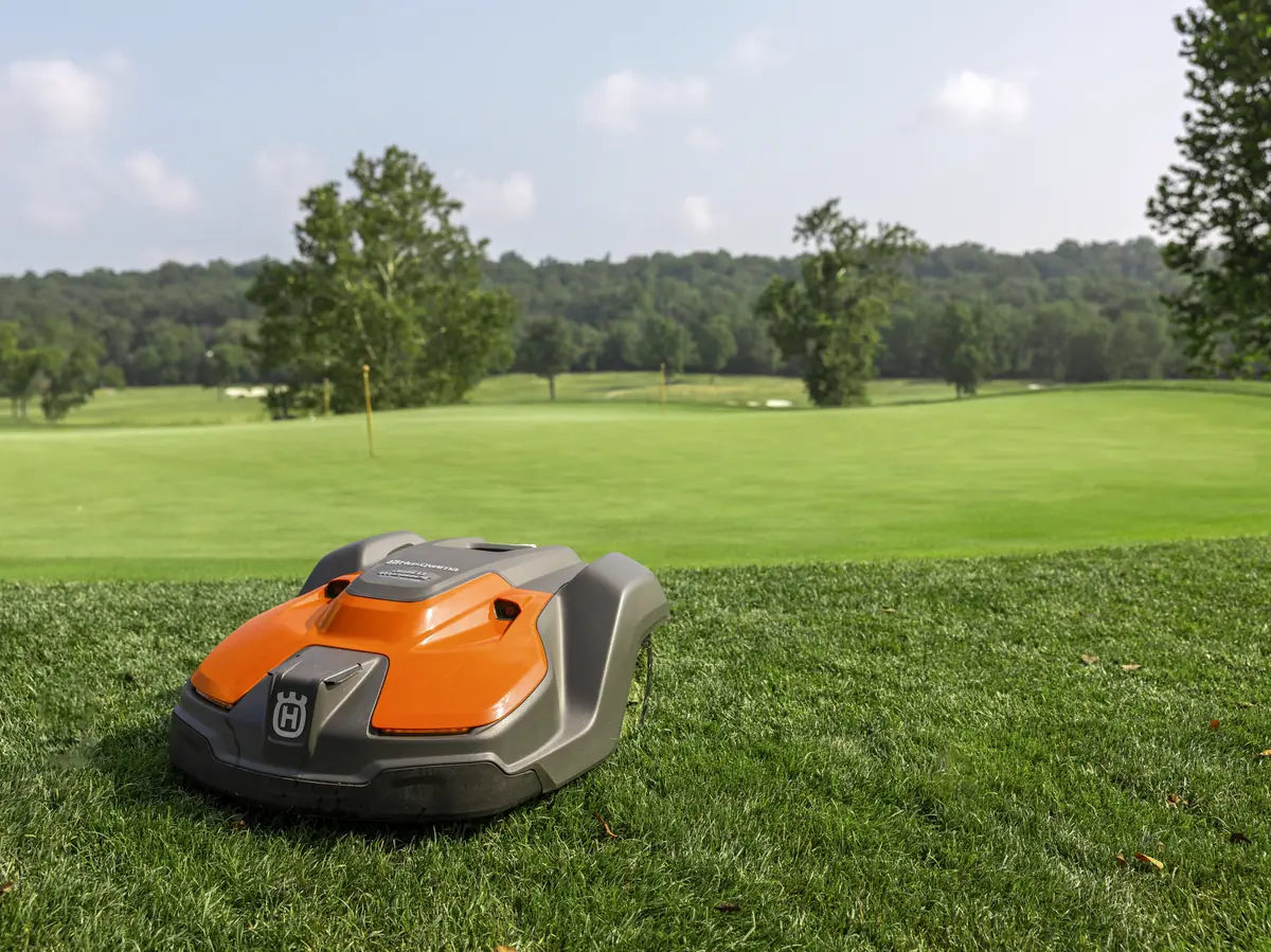 A robotic mower working on open commercial turf